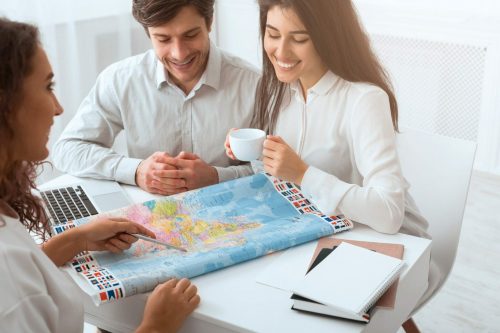 Plan,Journey.,Happy,Couple,Choosing,Place,For,Vacation,Using,Map Reisebuero Beratung Weltkarte 1649776351 scaled 500x0 c default