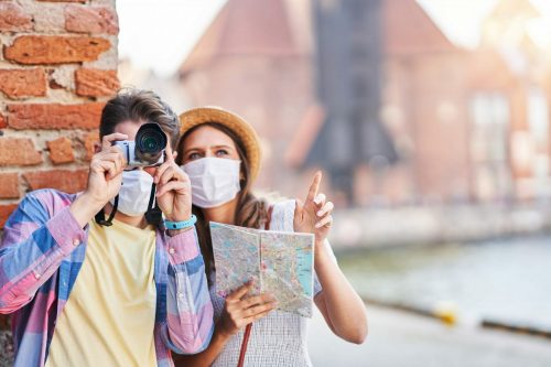 Adult,Tourists,In,Masks,Sightseeing,Gdansk,Poland shutterstock 1792135325 scaled 500x0 c default