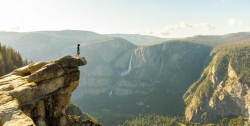 Hiker,At,The,Glacier,Point,With,View,To,Yosemite,Falls shutterstock 754753498 scaled 500x0 c default